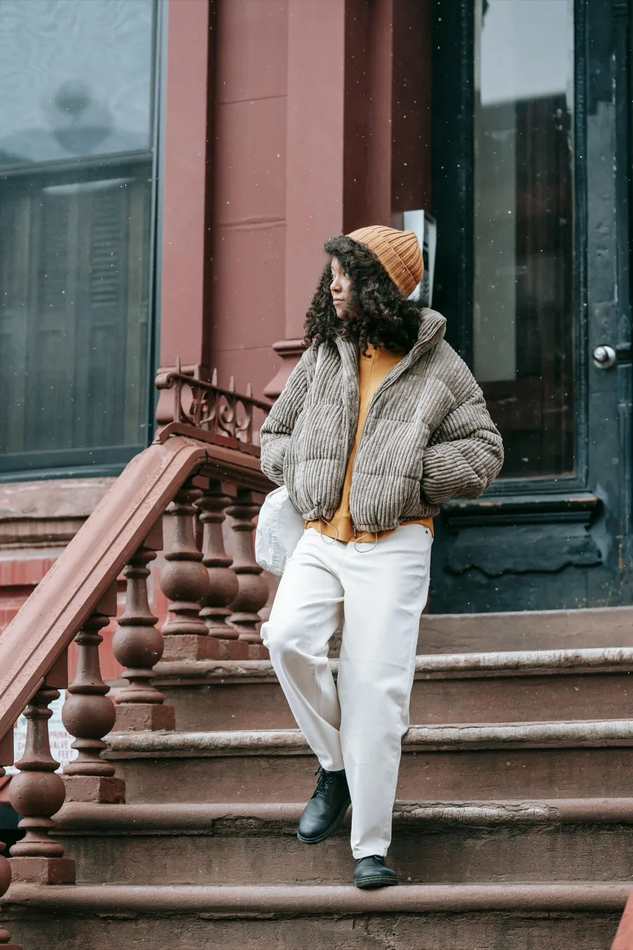 Grey corduroy puffer with mustard sweater and beanie